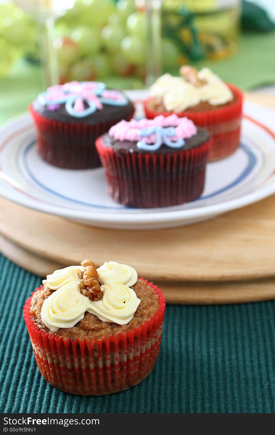 Fancy carrot and chocolate cupcakes with icing design on top