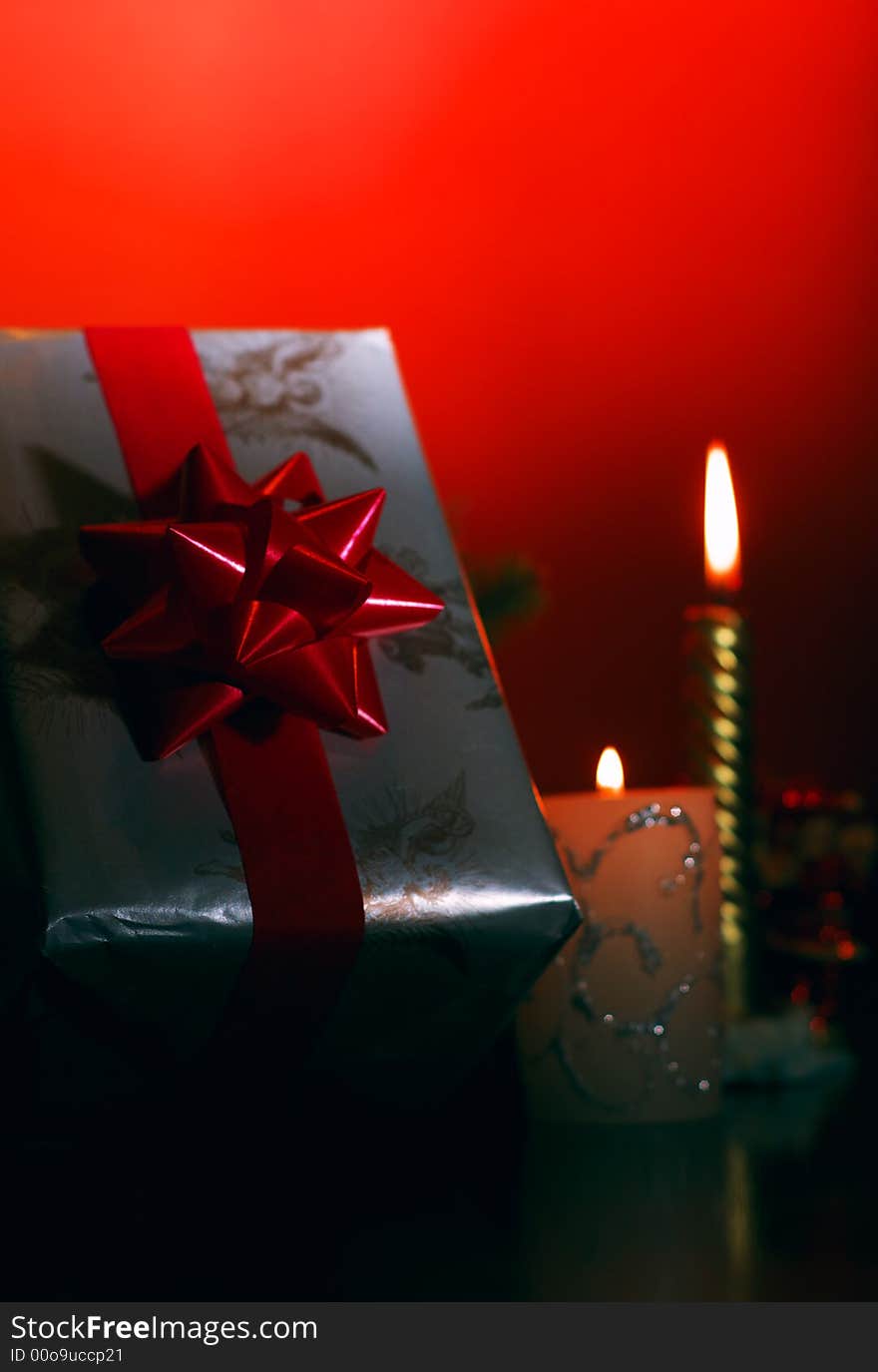 Ornaments - present, ribbon, candles on a red background. Ornaments - present, ribbon, candles on a red background