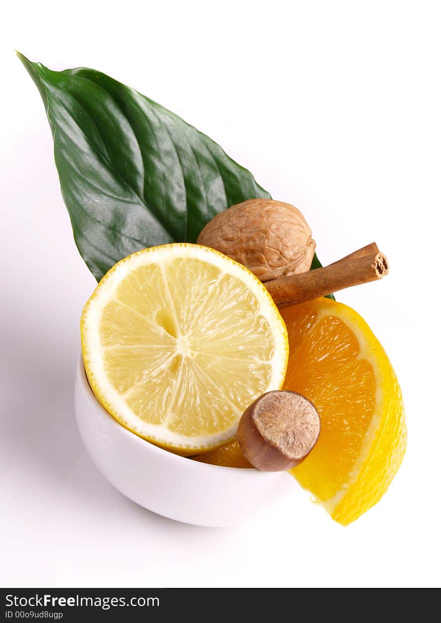 Lemon, oranges, cinnamon, nut and green leaf. Lemon, oranges, cinnamon, nut and green leaf