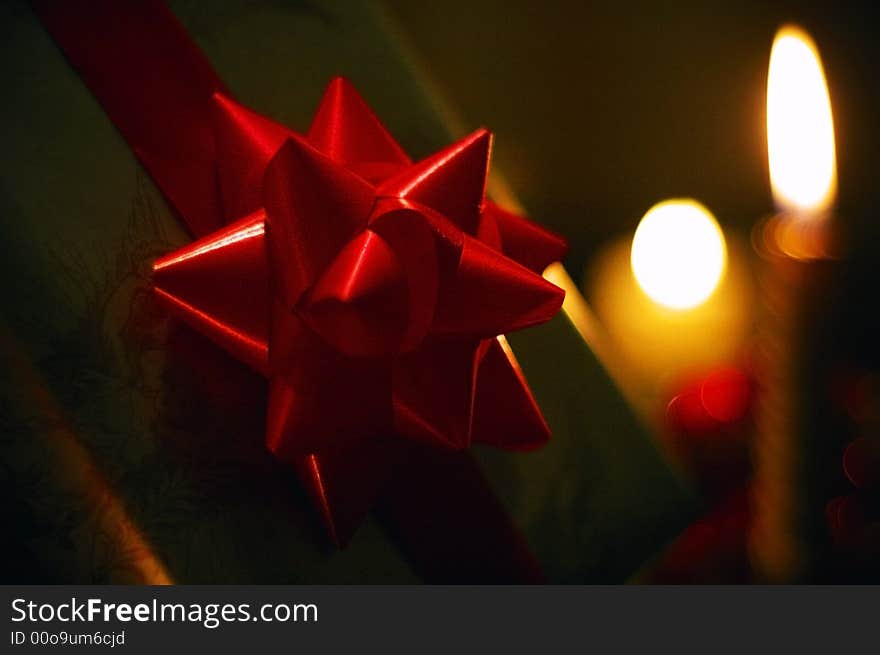 Ornaments - ribbon, present, candles on a dark background. Ornaments - ribbon, present, candles on a dark background