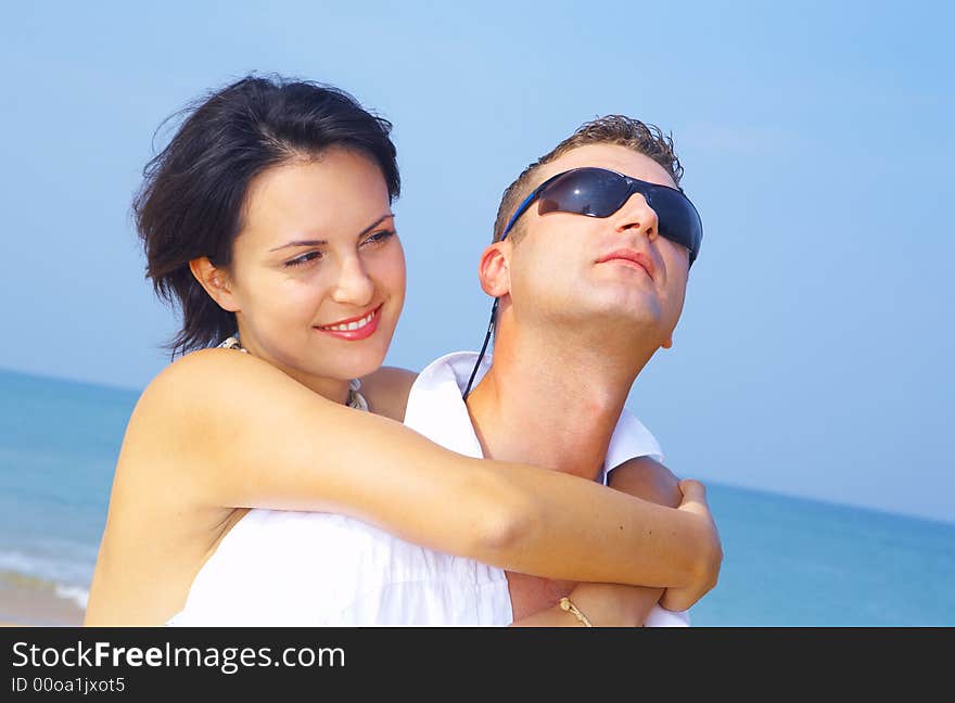 A portrait of attractive couple having fun on the beach. A portrait of attractive couple having fun on the beach