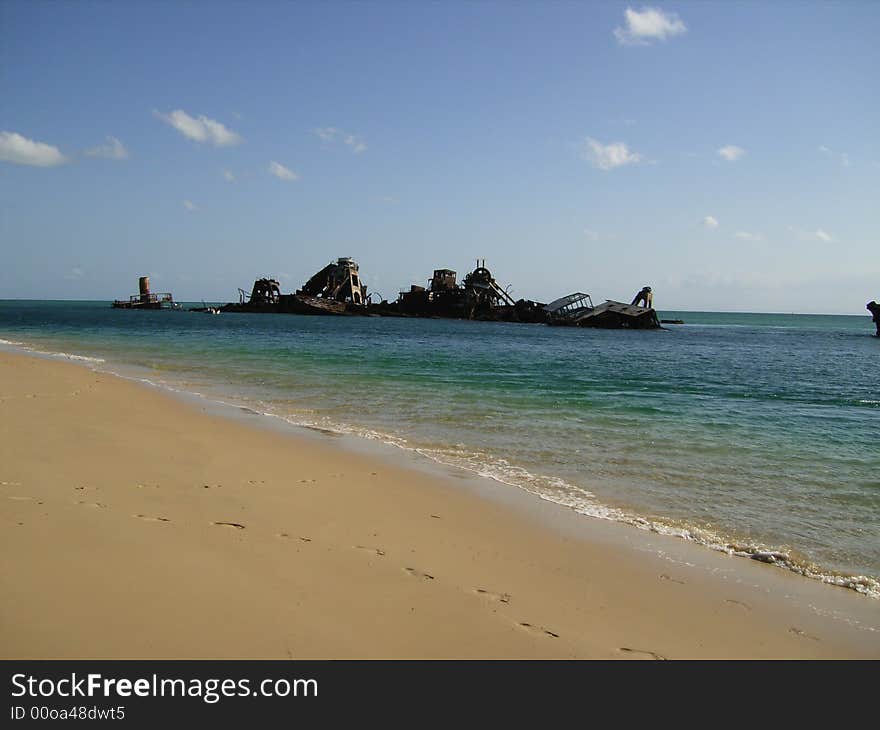 Several rusty ship wrecks at a beach