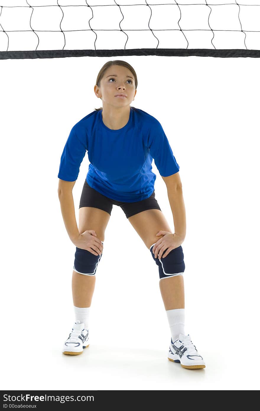 Young, beauty volleyball player. Standing in front of net and preparing to take the ball. White background. Whole body, front view. Young, beauty volleyball player. Standing in front of net and preparing to take the ball. White background. Whole body, front view