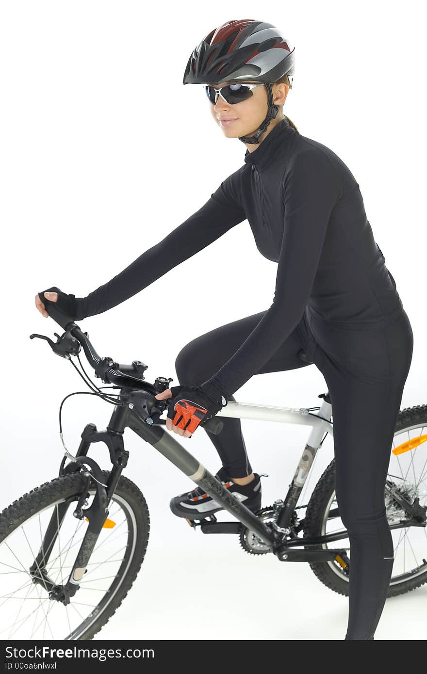 Young woman with helmet and sunglasses, sitting on mountain bike. White background, side view. Young woman with helmet and sunglasses, sitting on mountain bike. White background, side view