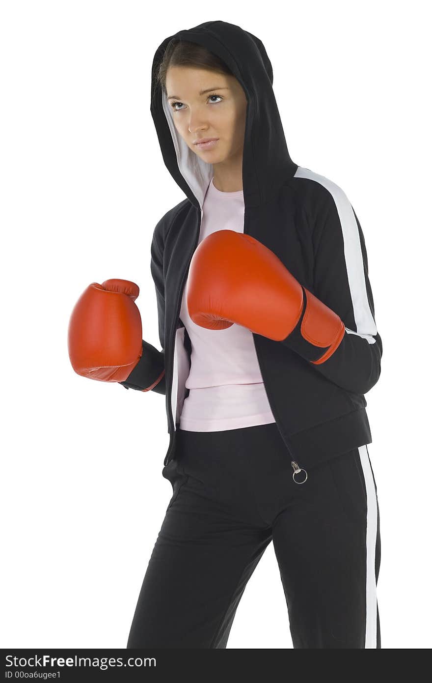 Young, hooded beauty with boxing gloves. Looking at something. White background, side view