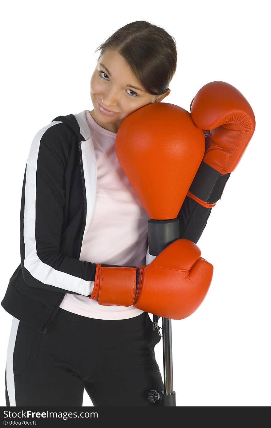 Young beauty with boxing gloves. Hugging punch bag. Smiling and looking at camera. White background, front view. Young beauty with boxing gloves. Hugging punch bag. Smiling and looking at camera. White background, front view