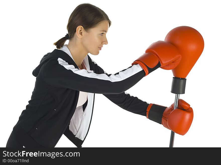 Young beauty with boxing gloves. Fighting with punch bag. White background, side view. Young beauty with boxing gloves. Fighting with punch bag. White background, side view