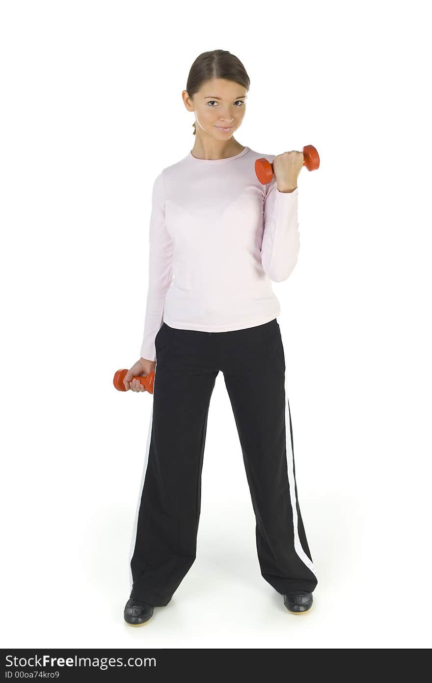 Young woman working out with dumbbells. Smiling and looking at camera. Isolated on white in studio, front view. Whole body. Young woman working out with dumbbells. Smiling and looking at camera. Isolated on white in studio, front view. Whole body