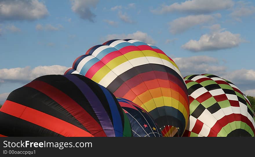 Four hot air balloons being inflated so they can lift off