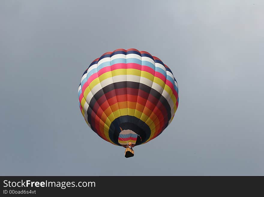 Looking up at a multi colored hot air balloon