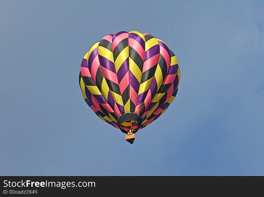 Multi colored hot air balloon from the ground below