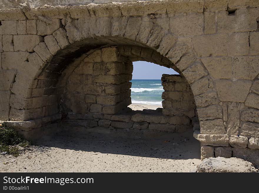 View of beach through hole in Roman aqueduct