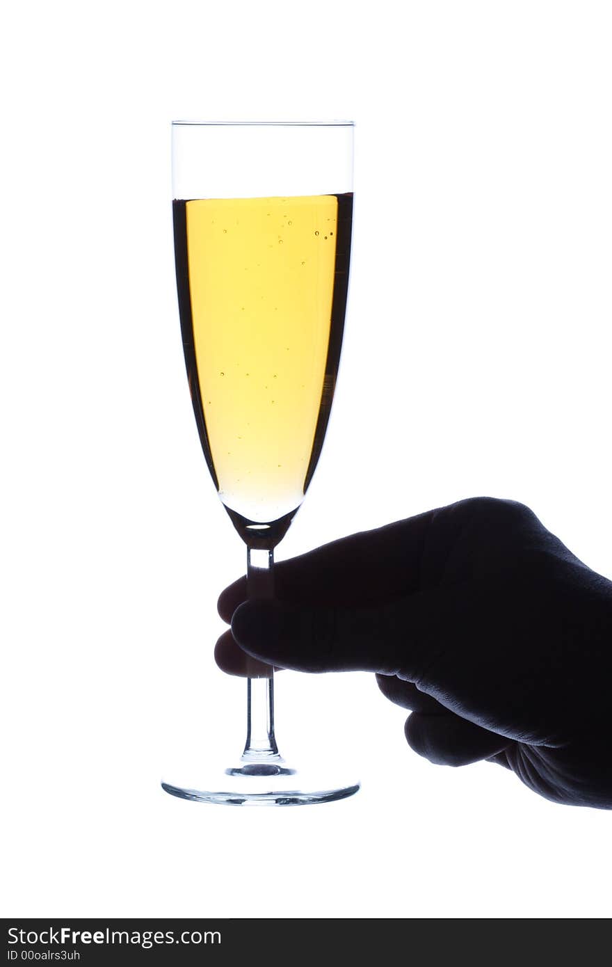 The hand holds a glass with champagne