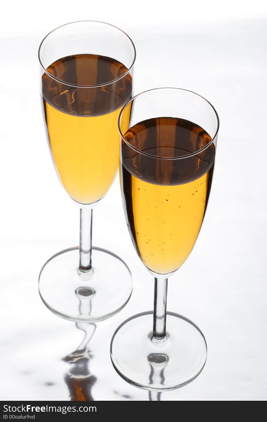 Two glasses in which champagne is poured