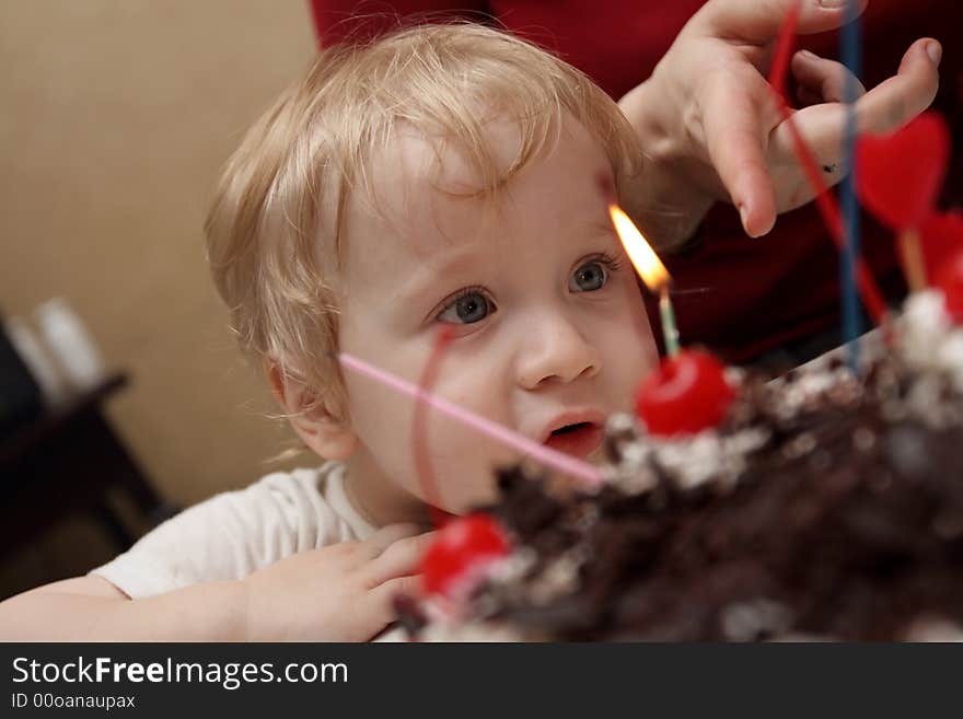 Boy looks at candles