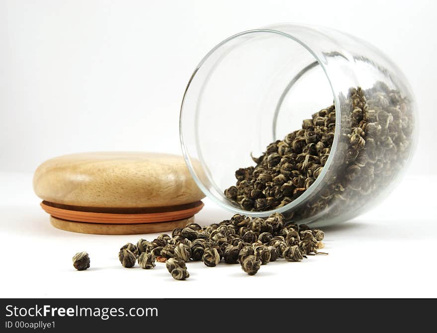 Glass can with green tea isolated over white background