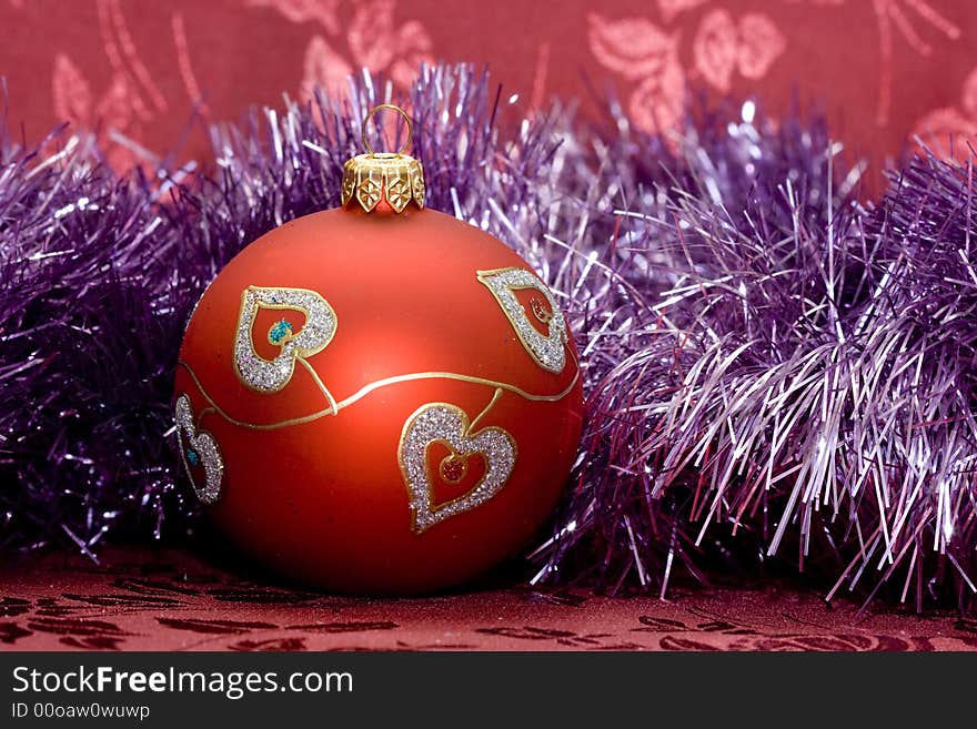 Red Christmas ball and violet garland