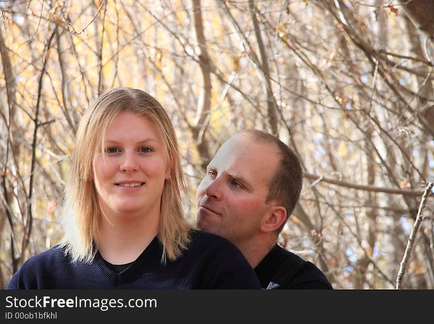 A happy young couple enjoying a forest in Autumn. A happy young couple enjoying a forest in Autumn.