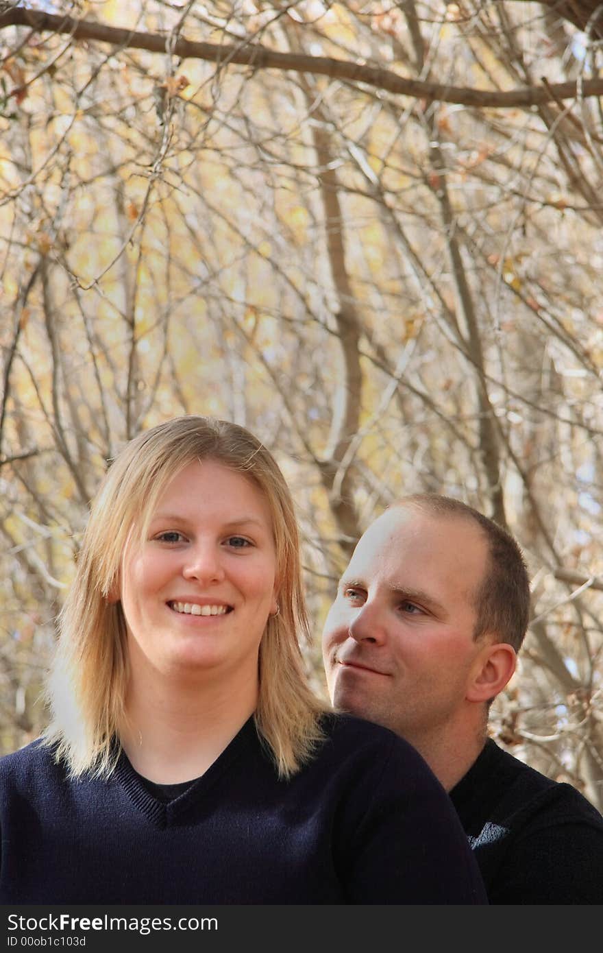 A young couple in love enjoying an Autumn forest. A young couple in love enjoying an Autumn forest.