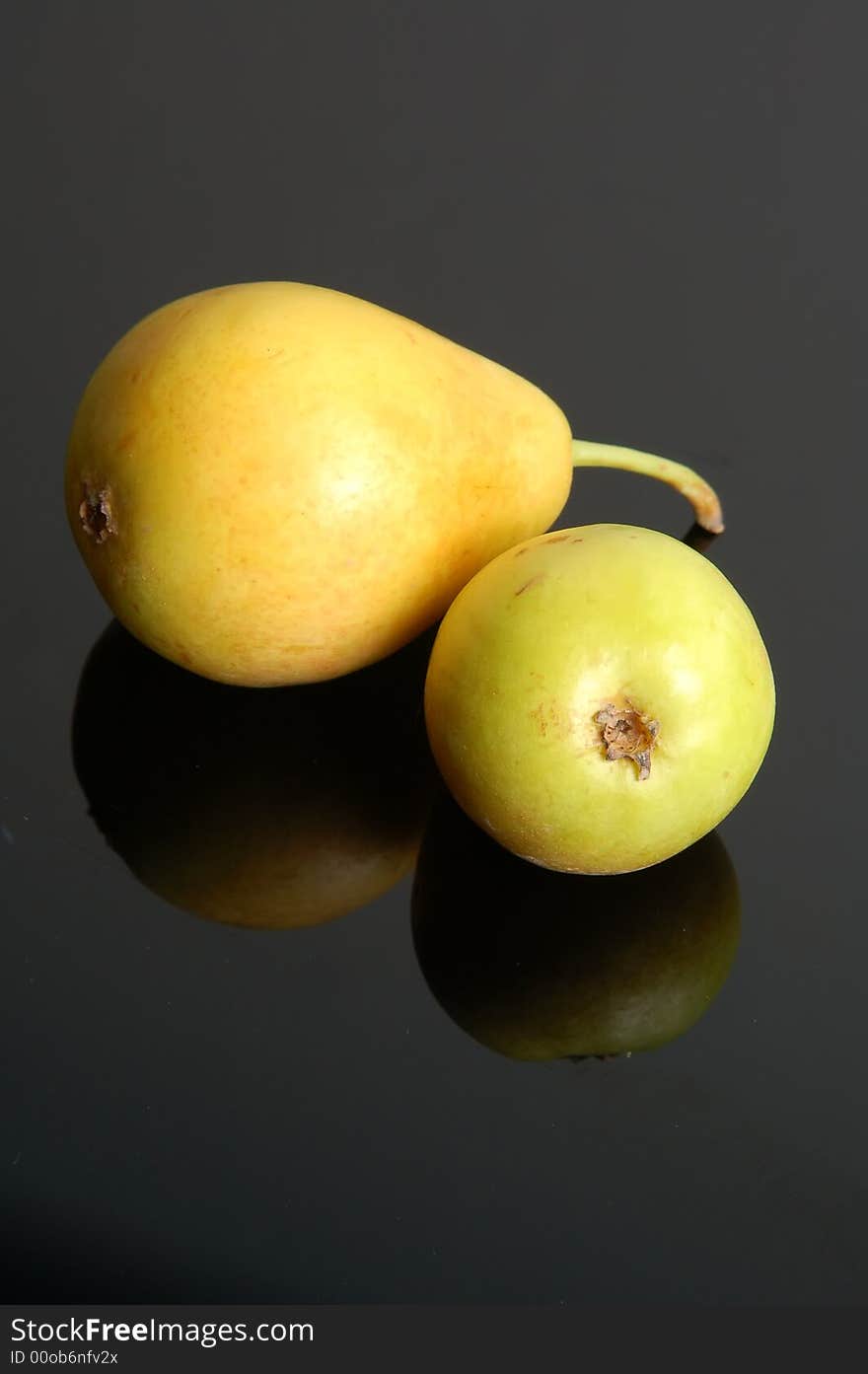 A fresh ripe pear showing some color isolated on a black background.