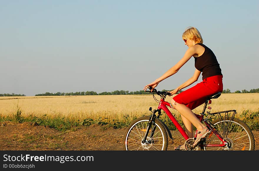 Woman biking at sunset