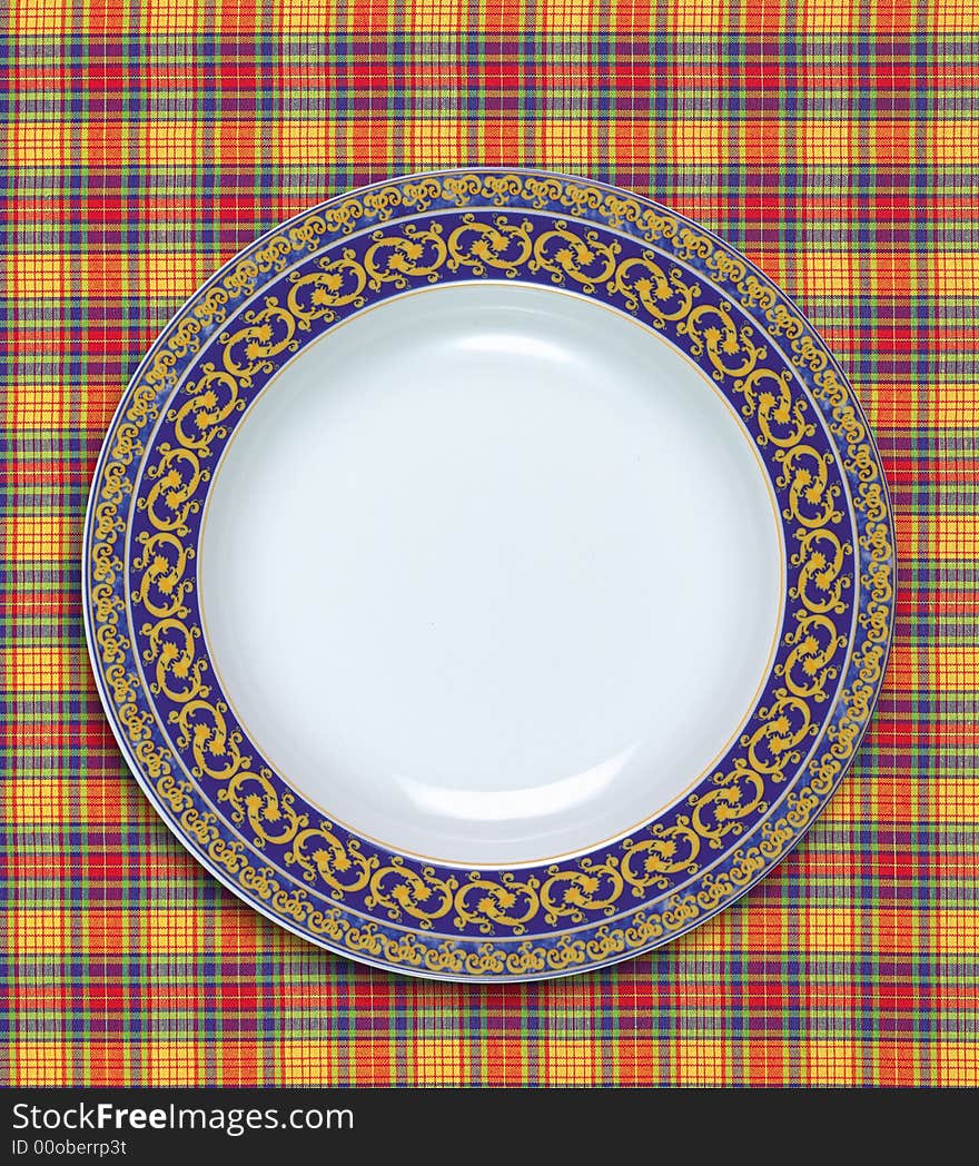 A empty dish on the table cloth