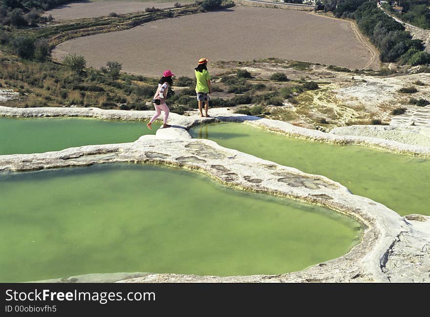 Two tourists visiting famous Pamukkale basins, Turkey.