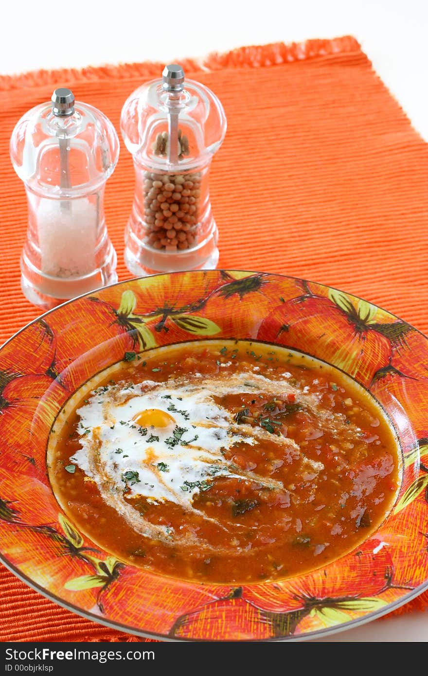 Chunky homemade tomato soup with chopped basil and garlic and a dash of olive oil