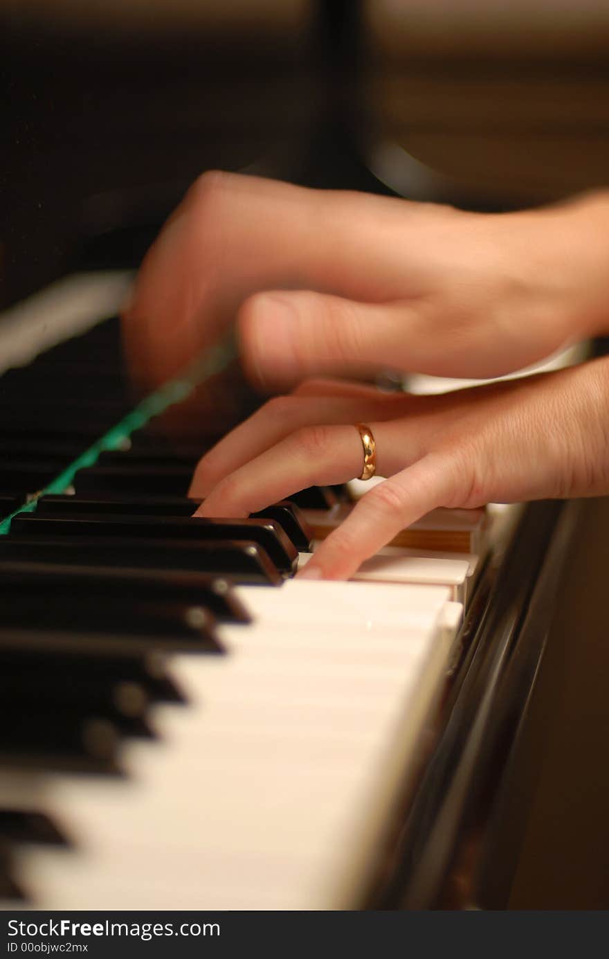 Two hands playing the piano