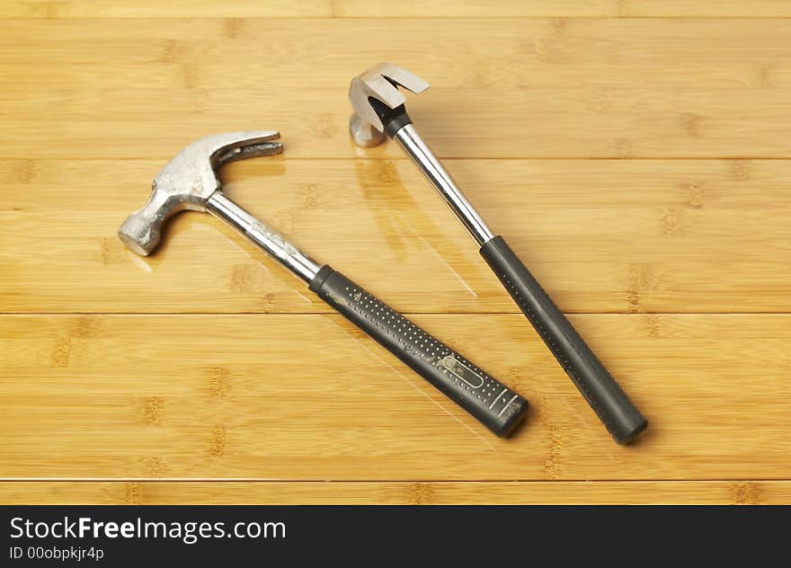 Two hammers on parquet floor