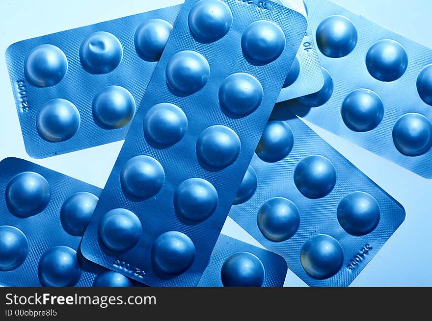 Blue pills on blue background