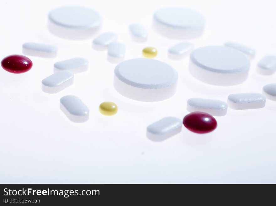 White pills on white background