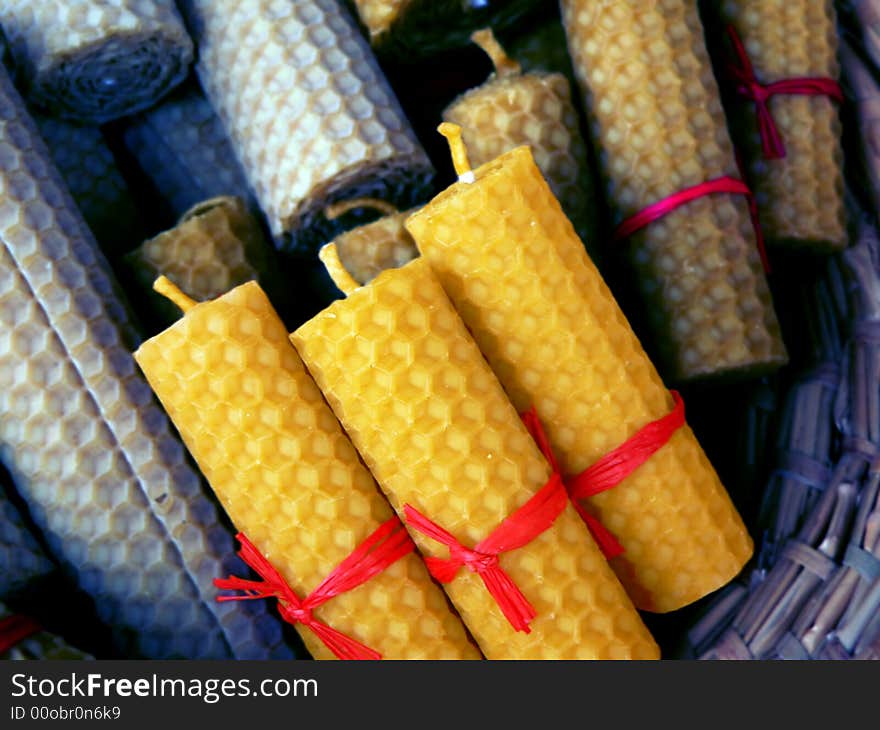 Coloured candle in hand-basket on sale. Coloured candle in hand-basket on sale