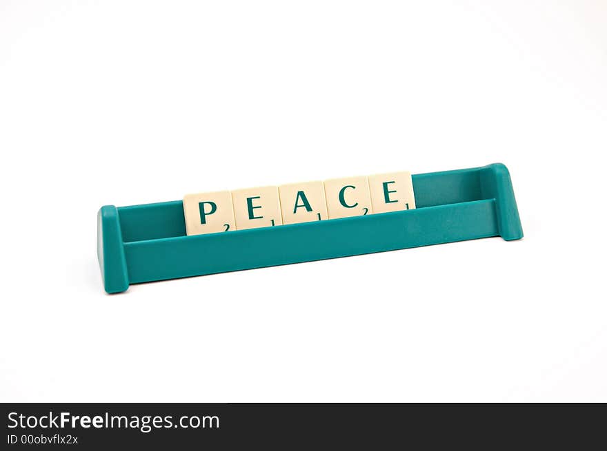 Peace inscription made of plastic letters on white background