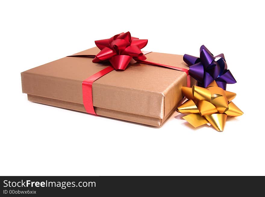 Golden box with colorful ribbons isolated on a white background. Golden box with colorful ribbons isolated on a white background