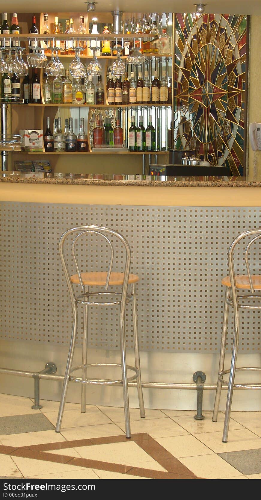 Modern bar kafe-bistro. Bar made of wood, stone and glass. Metal chairs.