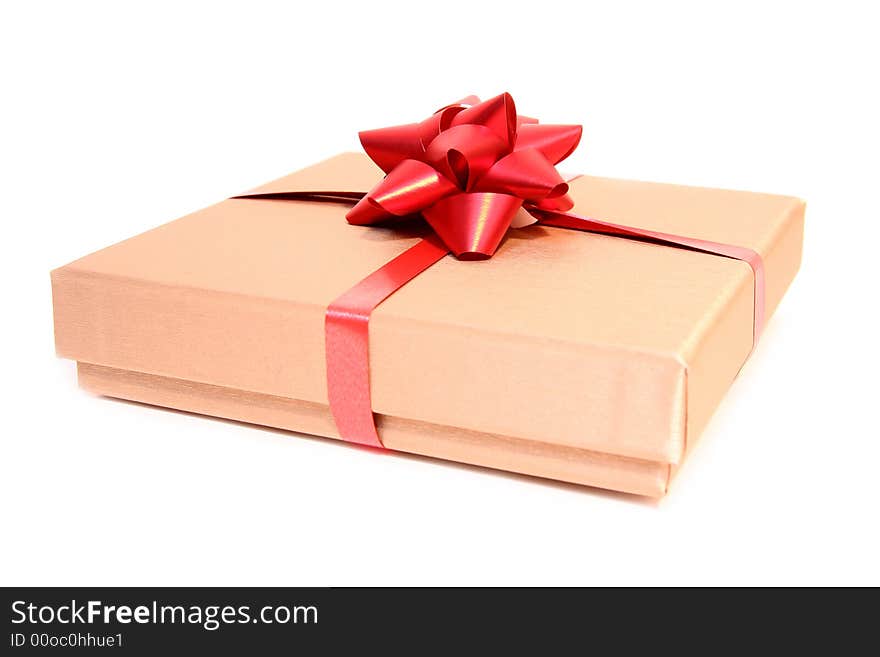 Golden box with a red ribbon isolated on a white background