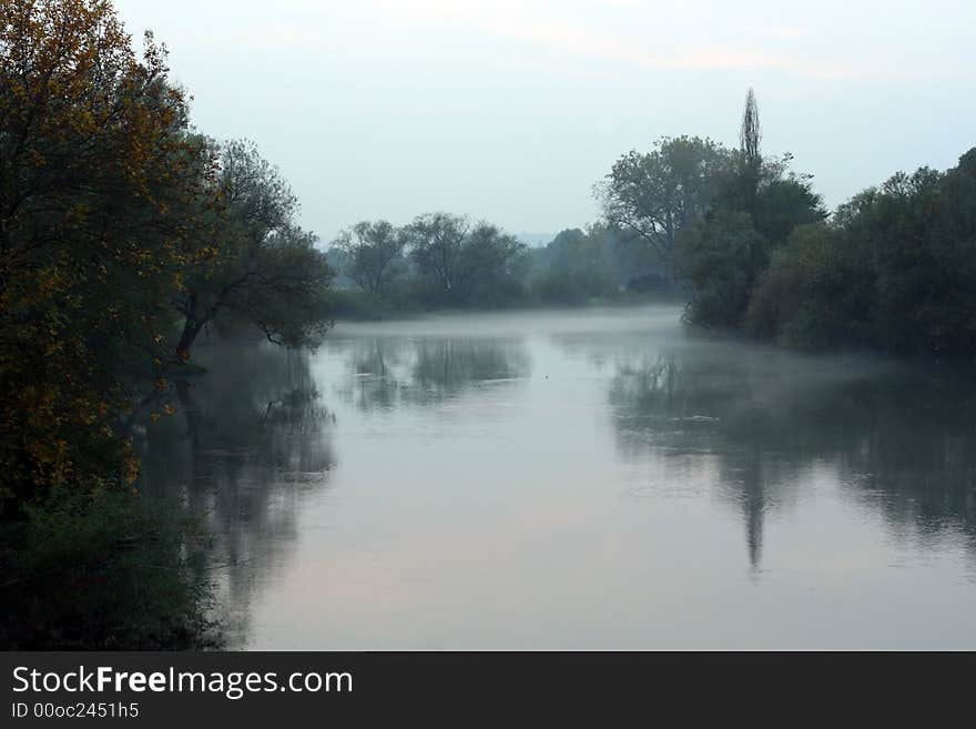 Evening autumn mist falling over the river Krka in Slovenia. Evening autumn mist falling over the river Krka in Slovenia.