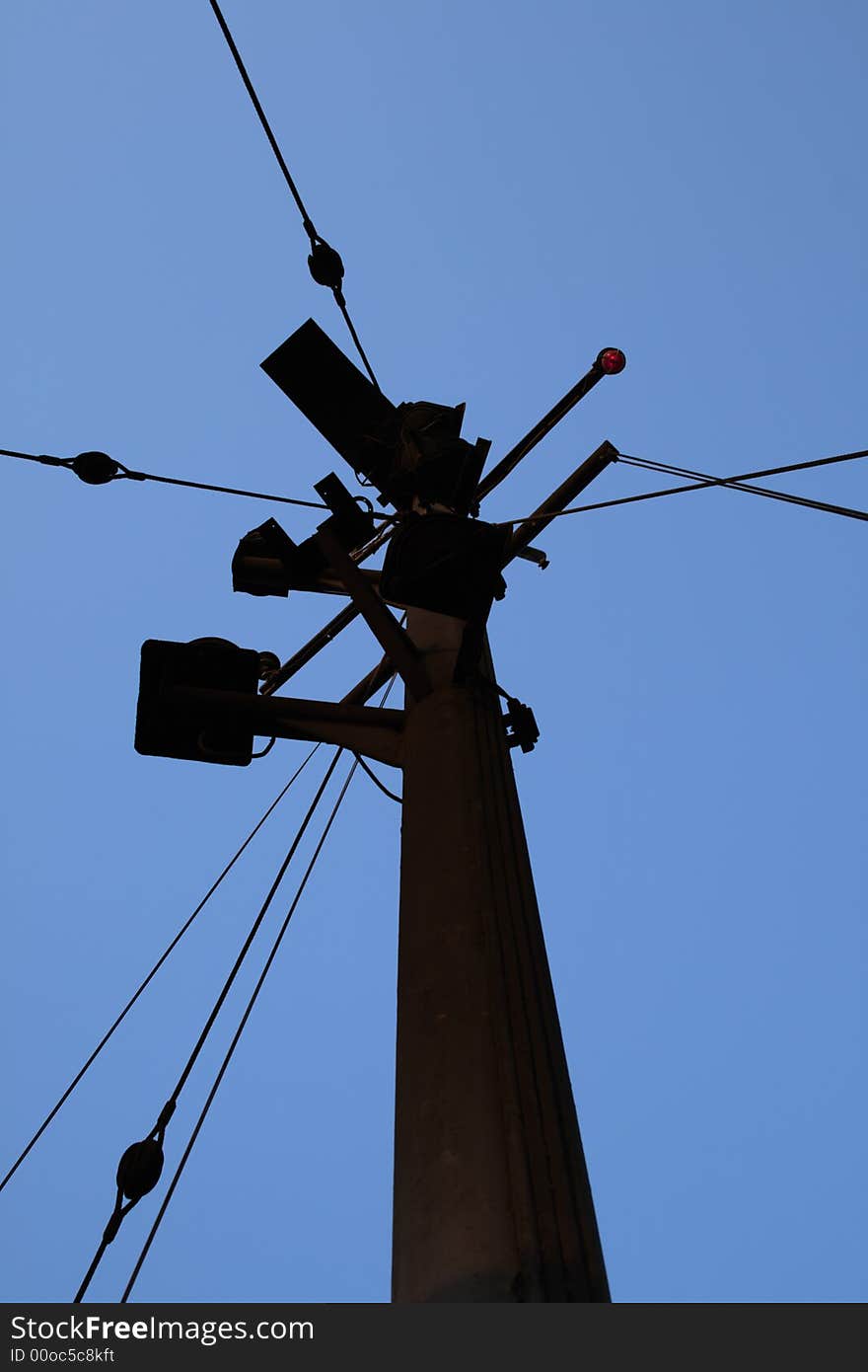 Silhouette of vessel's mast against blue cloudless sky. Silhouette of vessel's mast against blue cloudless sky