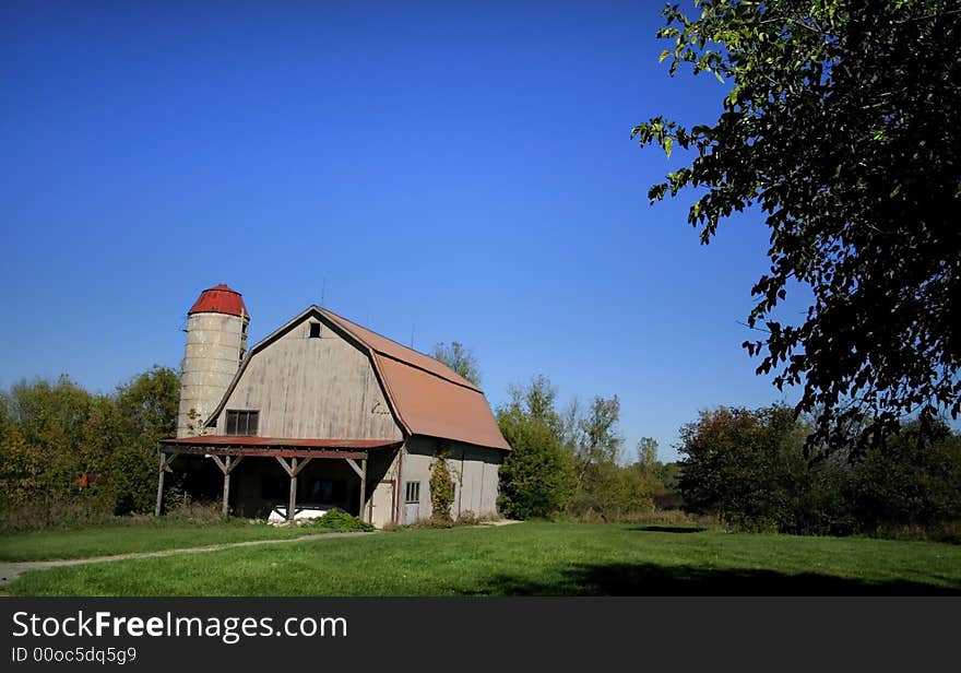 Old barn with bright blue sky background