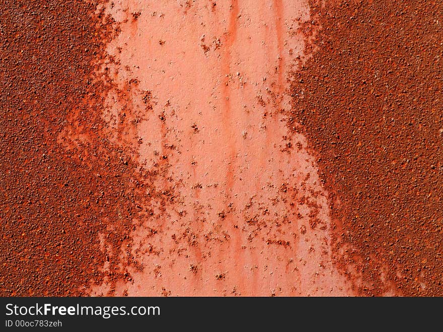 Piece of metal that is rusted and pitted. Piece of metal that is rusted and pitted