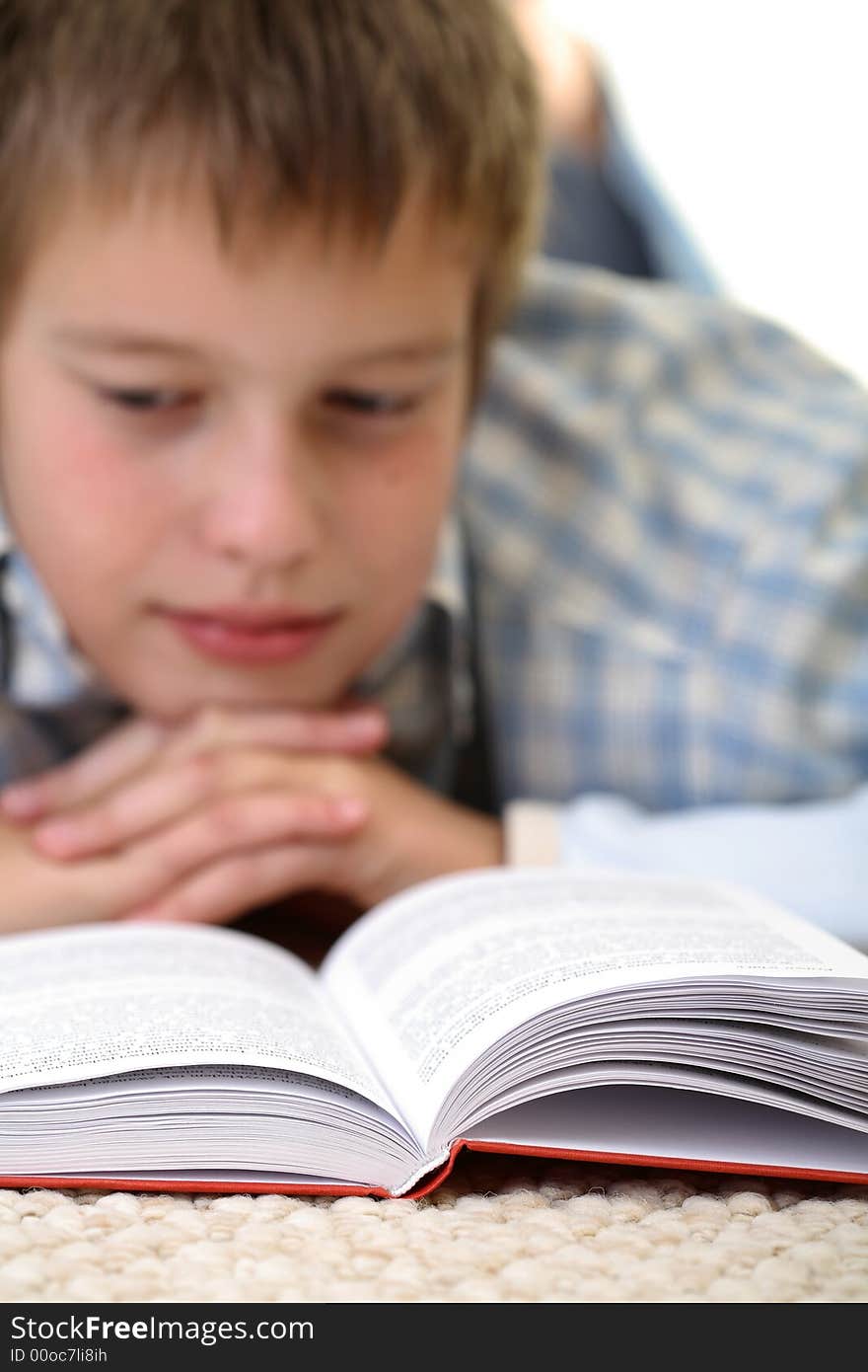 Boy learning on the floor