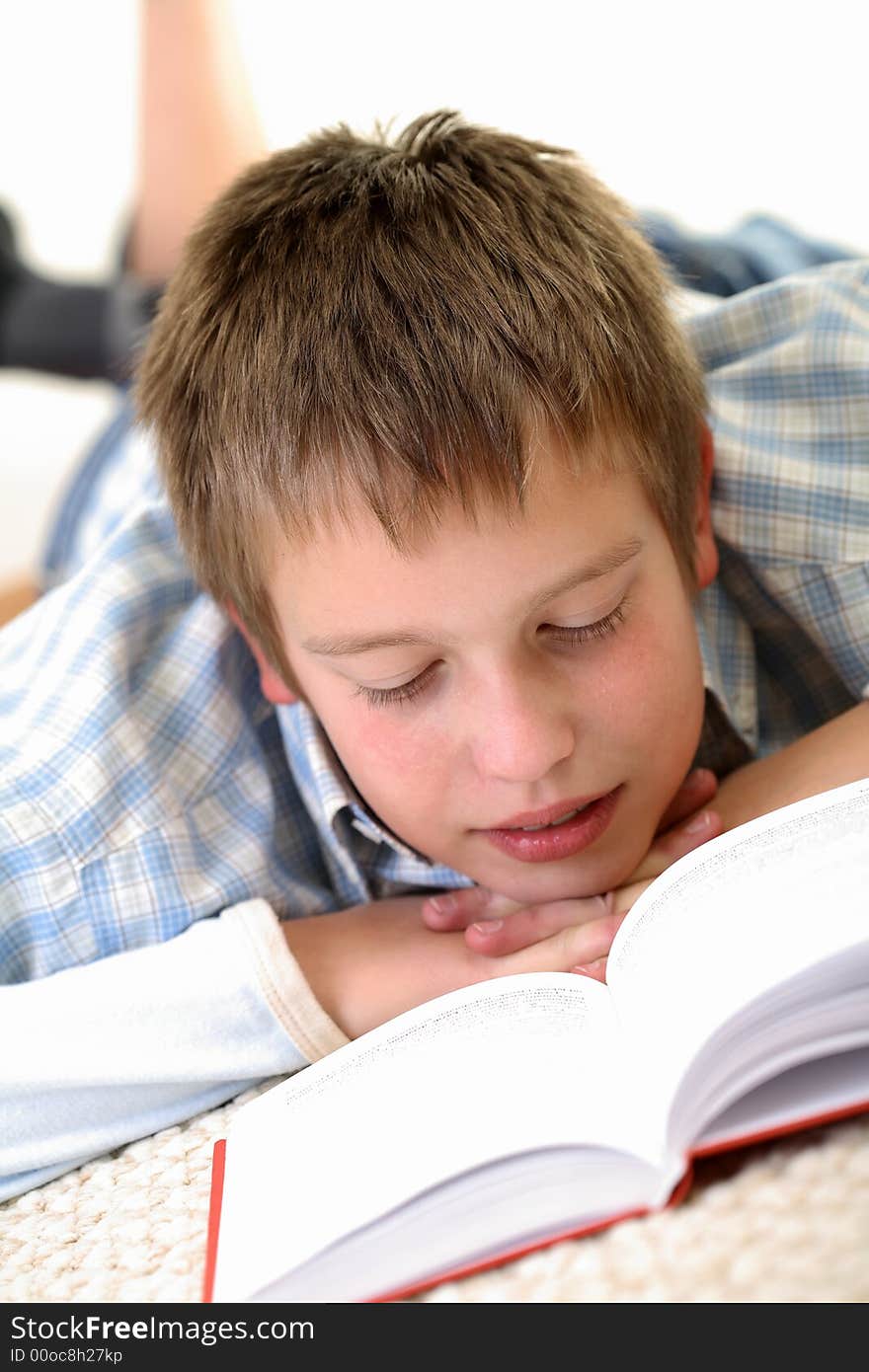 Young Boy learning on the floor