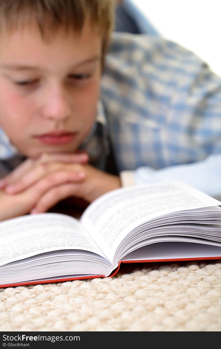 Boy learning on the floor