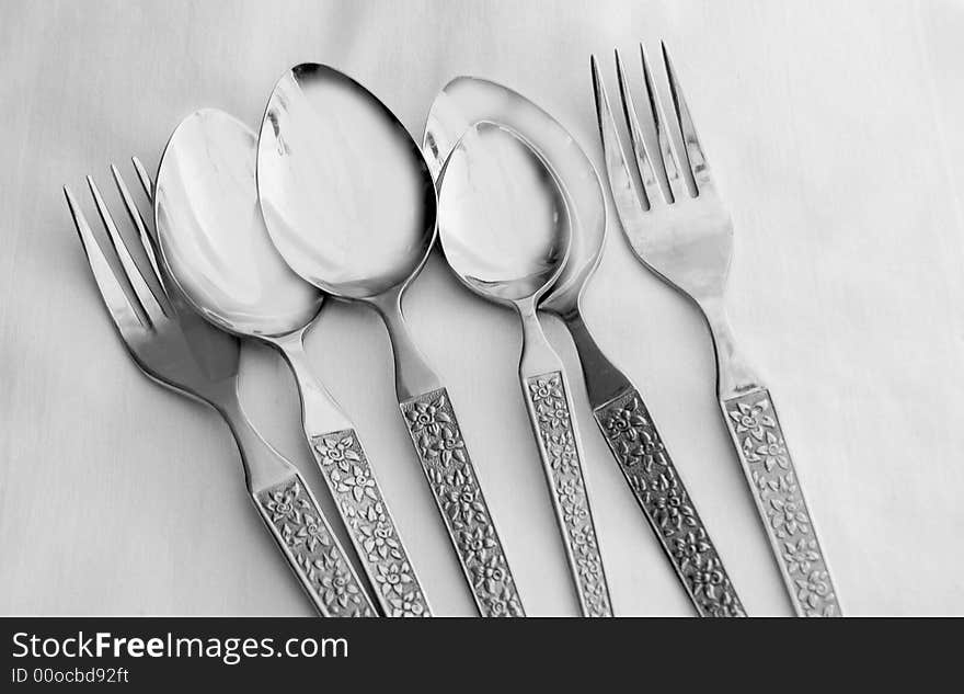 Stainless steel spoons and forks on a table