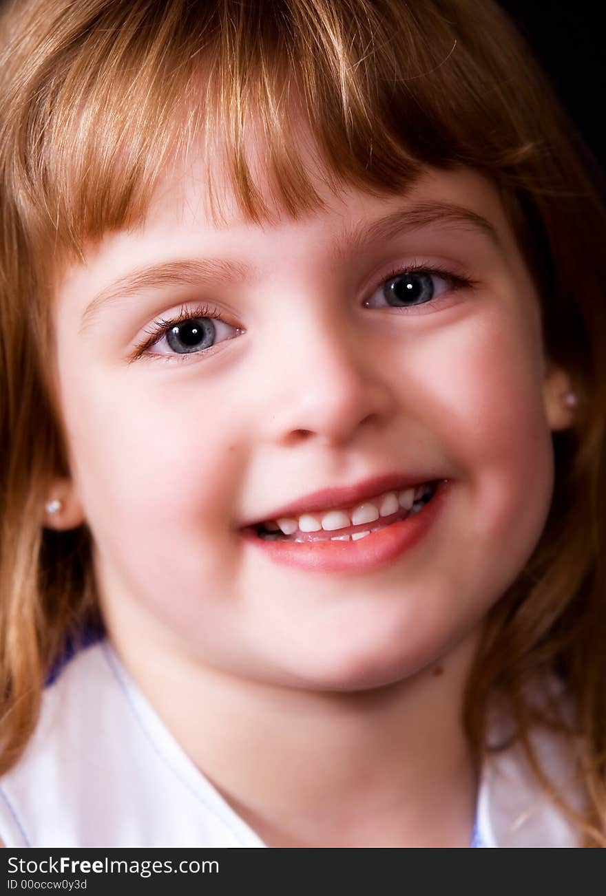 Face-only portrait of a smiling young elementary girl. Face-only portrait of a smiling young elementary girl.