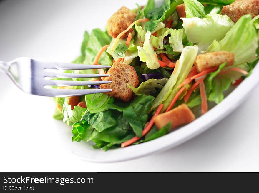 Close up of generic salad isolated on white background. Close up of generic salad isolated on white background.