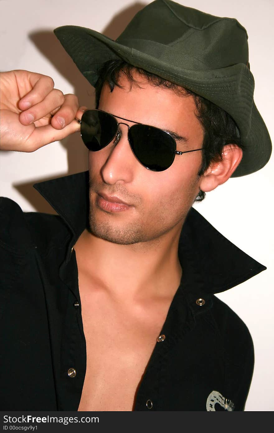 A young man wearing sunglasses isolated on a white background