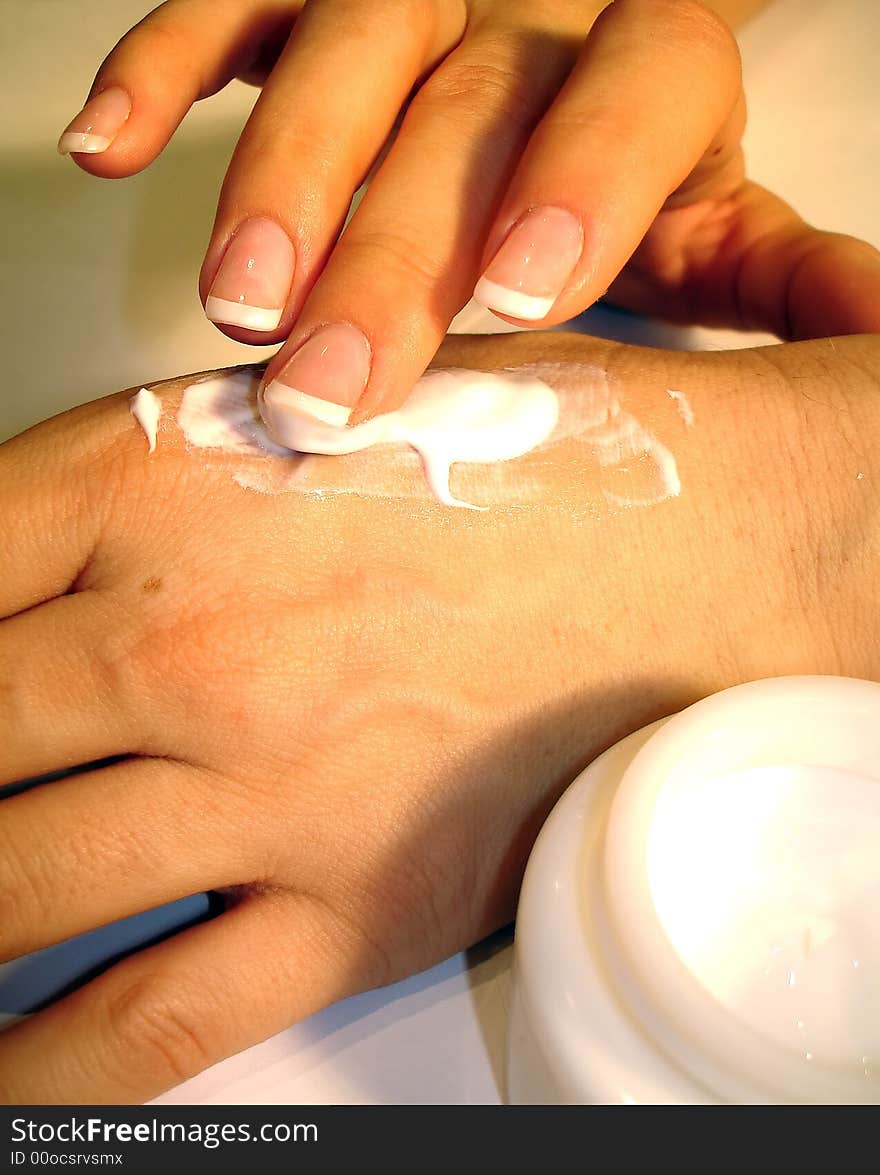 Women with beautiful nails massaging with cream. Women with beautiful nails massaging with cream