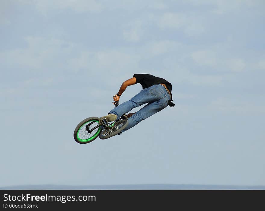 Jump with a mountain bike against sky